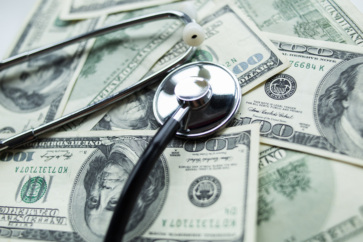 Stethoscope on the dollars. Medical costs.
