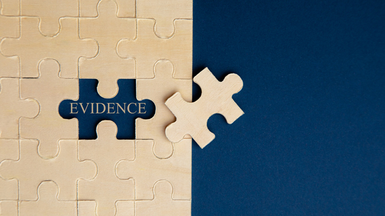 Puzzle on blue background, revealing the word evidence